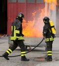 Two intrepid firefighters during the exercise with a tank full o