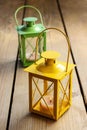 Two iron lanterns: yellow and green