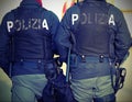 Two Italian cops with the words POLIZIA that means POLICE in Ita