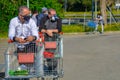 Two italian men with black face protection masks, waiting in line with shopping carts.daily routine in pandemic covid19 Royalty Free Stock Photo