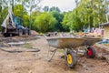 Two jack-lifts or two-wheeled construction trucks or hand-carts in construction site for carrying ground and sand by Royalty Free Stock Photo