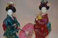 Japanese geisha doll with umbrella..and a fan. Royalty Free Stock Photo