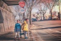 Two Japanese kids is waiting for school bus at Bus stop