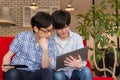 Two Japanese men watching contents on the internet with laptop computer
