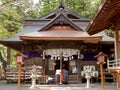 Two japanese worshipers at arakura sengen shrine in japan