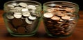 Two jars filled with coins on a wooden table. Generative AI image. Royalty Free Stock Photo