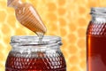 Two jars of honey, and wooden drizzler Royalty Free Stock Photo