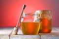 Two jars of honey on wooden table. Healthy food,