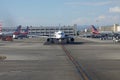 Two JetBlue Jets Taxi Among Parked American Airlines Jets at LAX