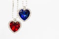 Two jewelry hearts blue and red hanging together