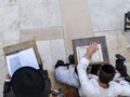 Two Jewish people praying the Torah