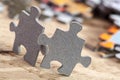 Two jigsaw puzzle pieces on table Royalty Free Stock Photo
