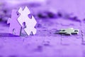 Two jigsaw puzzle pieces on a table joint together. Royalty Free Stock Photo