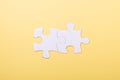 Two jigsaw puzzle pieces on yellow background. White puzzle Concept success of business Yellow background Royalty Free Stock Photo