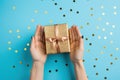 two joined hands holding a golden gift box with glittering ribbons, symbolizing gratitude and affection, human connection through