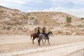 Two Jordanian mounted policemen patrol the tourist route in Petra in Wadi Musa city in Jordan