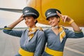 Two joyful air hostesses on the runway