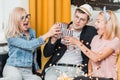 Cheerful group of friends eating popcorn at home Royalty Free Stock Photo