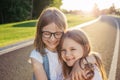 Two joyfull girls hugging against the sunset. Royalty Free Stock Photo