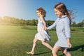 Two joyfull girls running on the field. Royalty Free Stock Photo