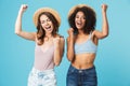 Two joyous summer girls 20s with different color of skin wearing Royalty Free Stock Photo