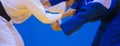 Two judo fighters in white and blue uniform Royalty Free Stock Photo