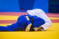 Two judo fighters in white and blue uniform Royalty Free Stock Photo