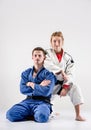 The two judokas fighters posing on gray Royalty Free Stock Photo