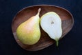 Two juicy pears are placed on a wooden plate Royalty Free Stock Photo