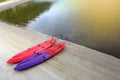 Two Kayak Canoe small boat in red and purple on sand beach ocean