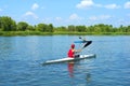 Two kayakers, boy and girl, meet on river Royalty Free Stock Photo