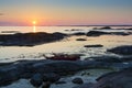 Two kayaks on a cliff sunset