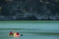 Two kayaks on the lake near the rocky shoreline. Turquoise water. Water Reservoir in Spain.