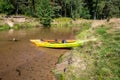 Two kayaks left on the bank of a river in the middle of the forest. Zawdzkie, Mala Panew river, Poland