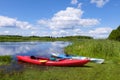 Two kayaks by the river bank. Scenic rural landscape of wild river, rafting along a river, water sport concept