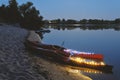 Two kayaks on the river, illuminated by lights Royalty Free Stock Photo