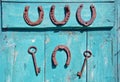 Two keys and four horseshoes hanging on wooden door Royalty Free Stock Photo