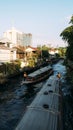 Two khlong boats pass by each other in the narrow canal in Bangkok, Thailand