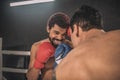 Two kickboxers fighting on a boxing ring and looking aggressive Royalty Free Stock Photo