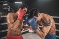 Two kickboxers fighting on a boxing ring and looking aggressive Royalty Free Stock Photo
