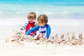 Two kid boys building sand castle on tropical beach of Bora Bora Royalty Free Stock Photo