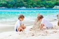 Two kid boys building sand castle on tropical beach Royalty Free Stock Photo