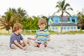 Two kid boys building sand castle on tropical beach Royalty Free Stock Photo