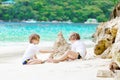 Two kid boys building sand castle on tropical beach Royalty Free Stock Photo