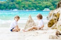 Two kid boys building sand castle on tropical beach Royalty Free Stock Photo