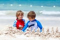 Two kid boys building sand castle on tropical beach of Mexiko Royalty Free Stock Photo
