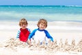 Two kid boys building sand castle on tropical beach of Playa del Carmen, Mexico Royalty Free Stock Photo