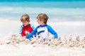 Two kid boys building sand castle on tropical beach of Playa del Carmen, Mexico Royalty Free Stock Photo