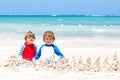 Two kid boys building sand castle on tropical beach of Playa del Carmen, Mexico Royalty Free Stock Photo