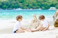 Two kid boys building sand castle on tropical beach Royalty Free Stock Photo